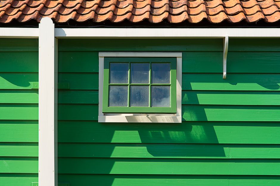 Painted house wall with a window and trim