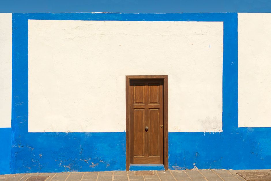 Painted house wall with a window and trim